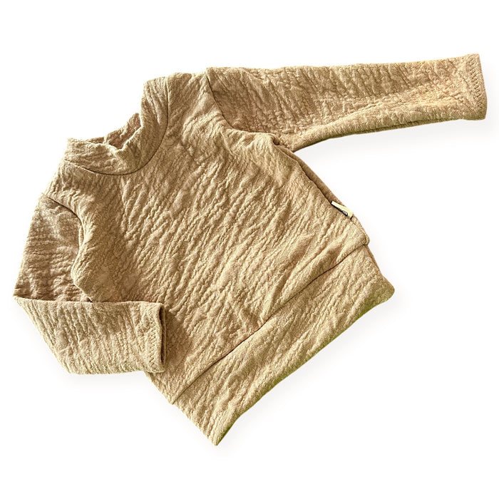Beige camel  textured sweater on a white background